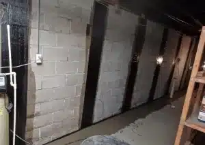 Carbon fiber wall reinforcement straps installed on a basement block wall to stabilize foundation pressure