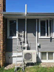 Radon mitigation system installed on the exterior of a home in Rochester, MN